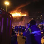 A medic stands near the ambulance at Crocus City Hall