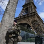 A soldier patrols at the Eiffel Tower