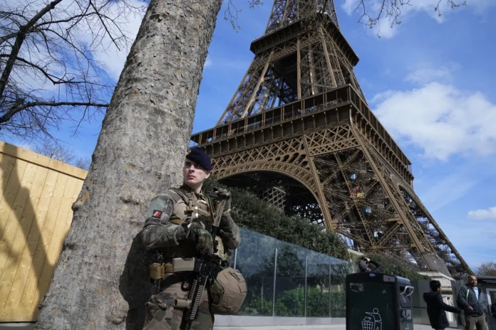 A soldier patrols at the Eiffel Tower
