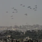 An aircraft airdrops humanitarian aid